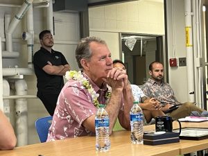 U.S. Representative Ed Case listens to UH students present NIWC projects